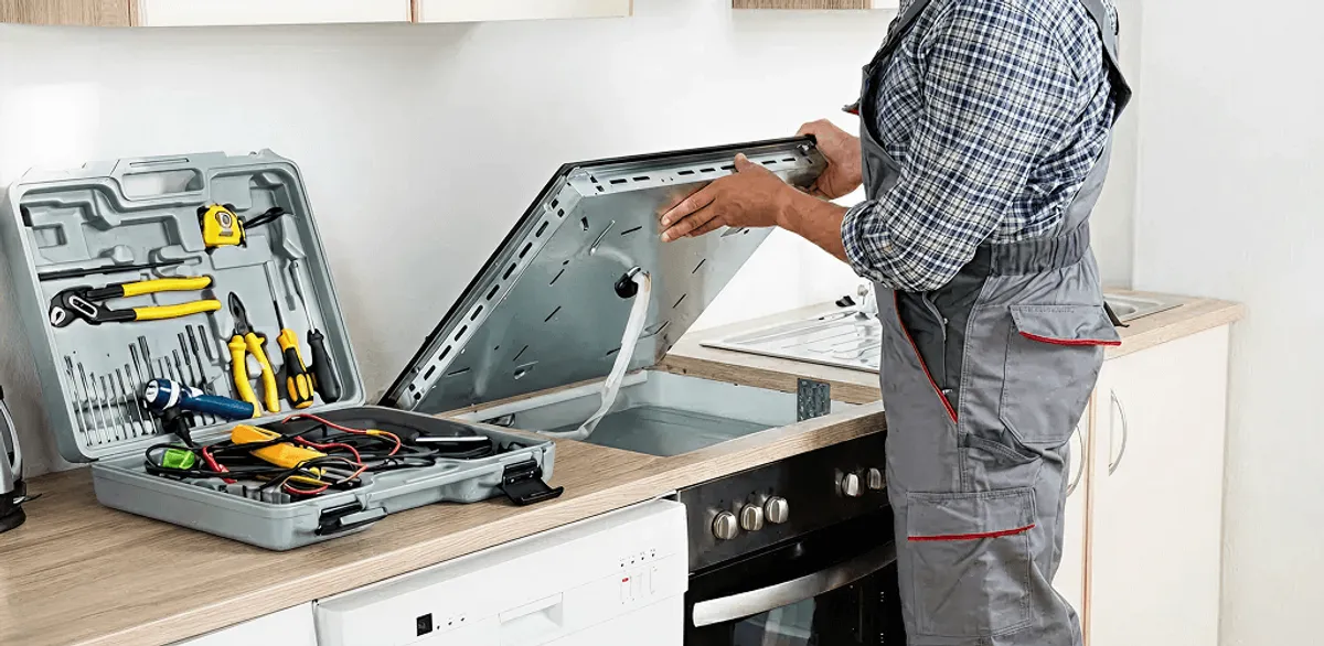 Handyman repairing a cooktop and checking wiring connections in Stamford, CT