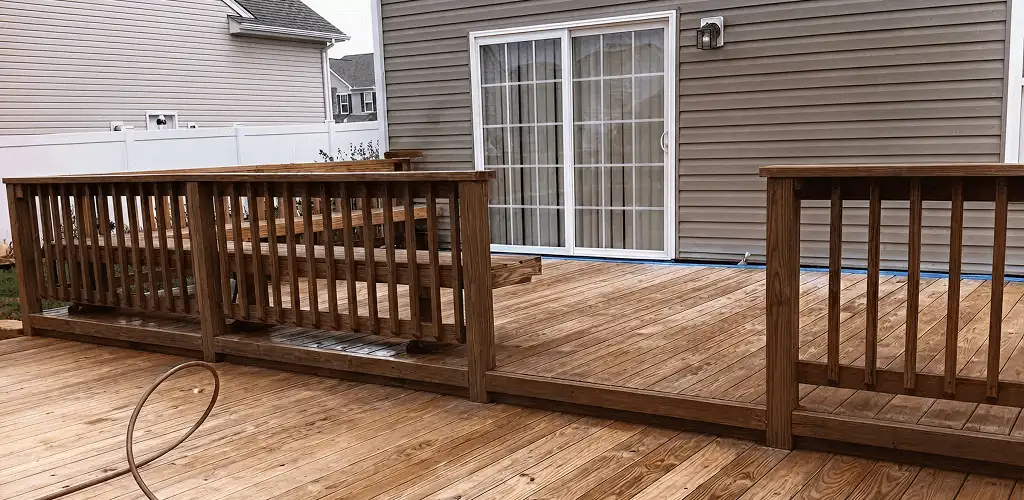 Deck sealing service protecting a backyard wood deck and railings in Stamford, CT