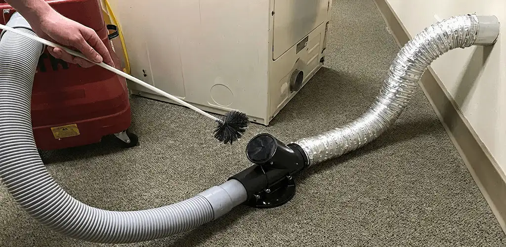Dryer vent cleaning service removing lint from a dryer duct connection in Stamford, CT