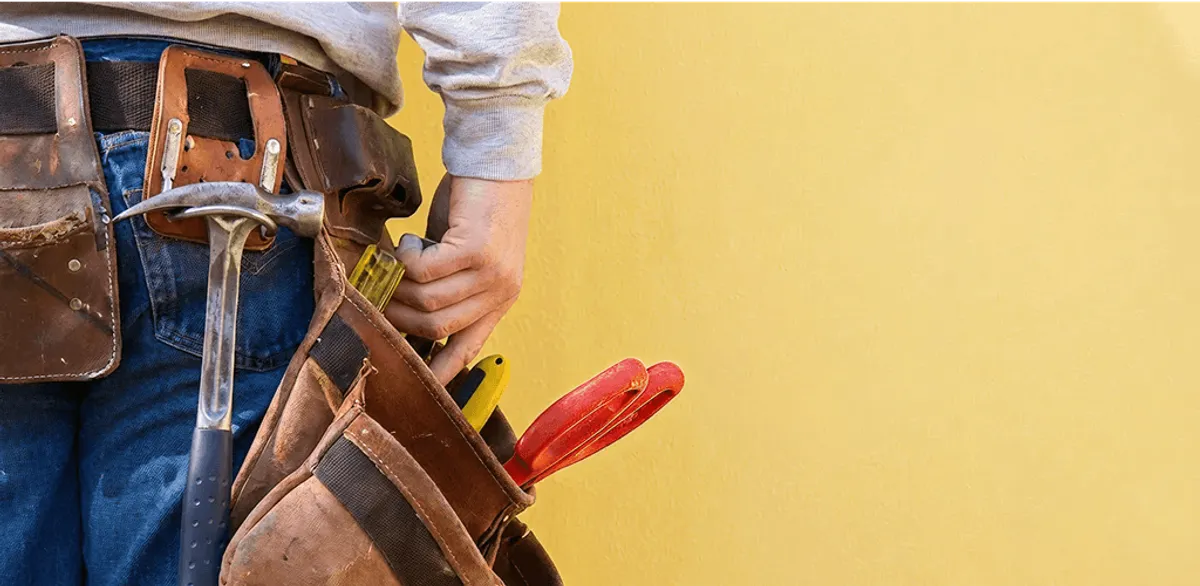 Handyman with tool belt ready for home repairs and maintenance in Stamford, CT