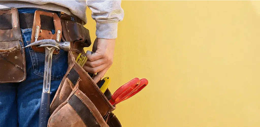 Handyman with tool belt ready for home repairs and maintenance in Stamford, CT