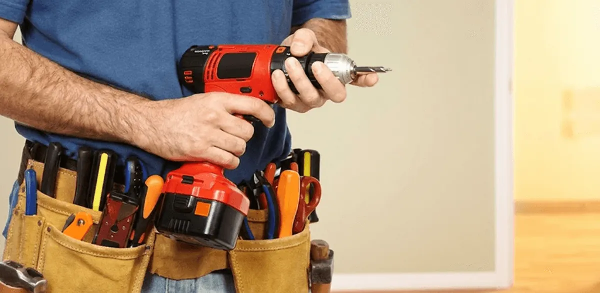 Handyman holding a power drill for home repairs and installations in Stamford, CT