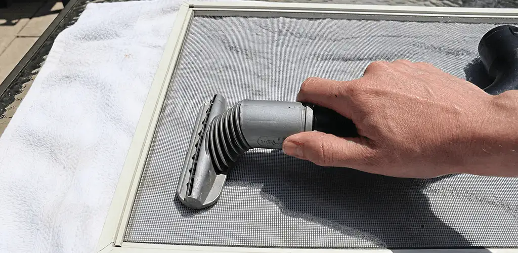 Window screen repair cleaning and fixing a damaged screen mesh in Stamford, CT